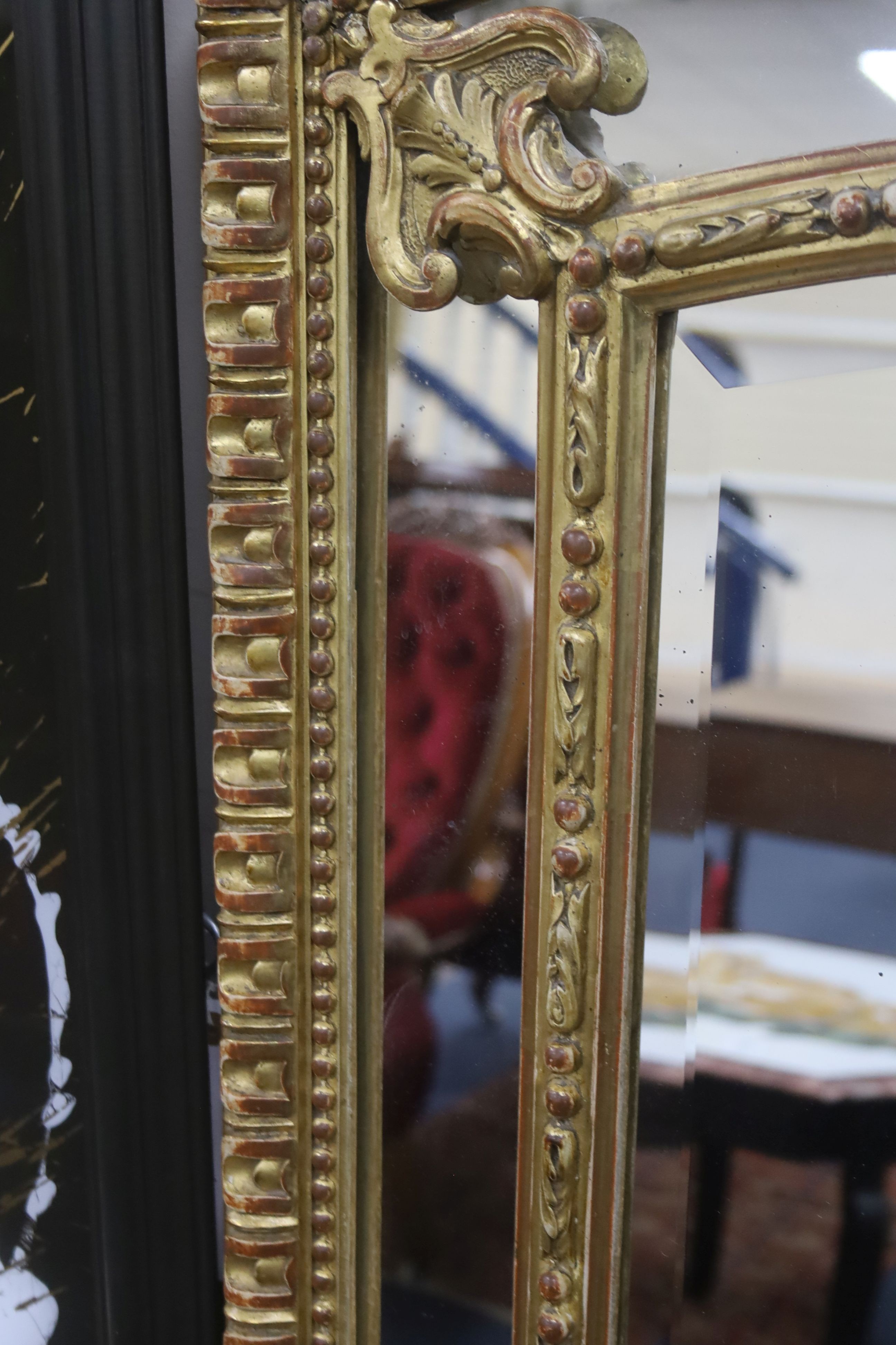 A 19th century giltwood and gesso overmantel mirror with Olympic Torch & Laurel Crown, side cushions with decorated bead detail, width 92cm, height 153cm